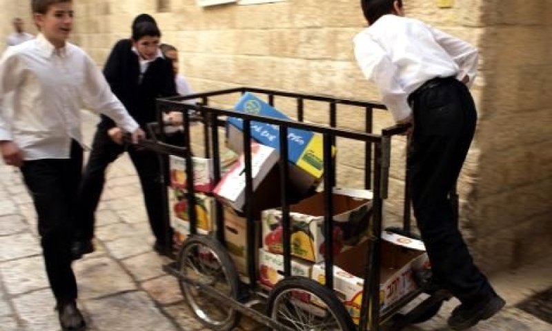 ילדים נושאים עגלת קרטוני פירות וירקות ברובע היהודי [צילום: פלאש 90]