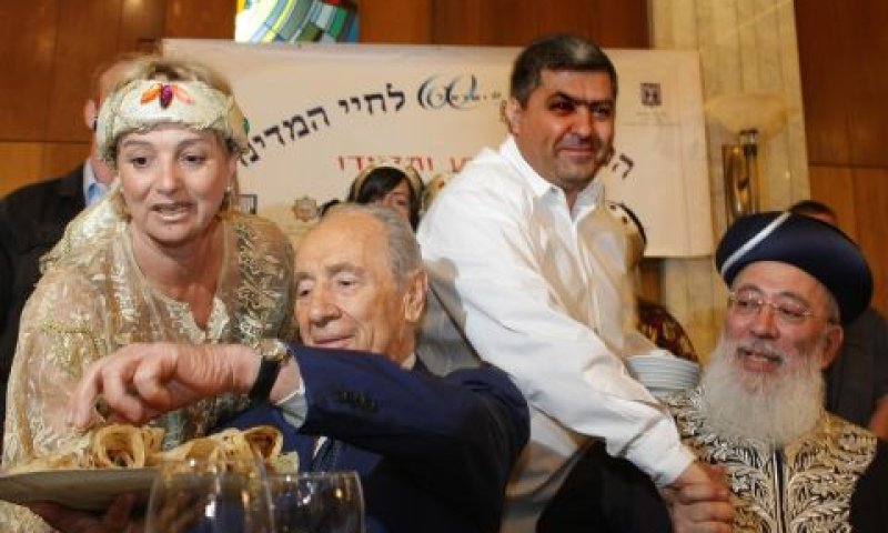הנשיא פרס מתכבד במופלטה. לימינו הרב הראשי שלמה עמאר [צילום: פלאש 90]