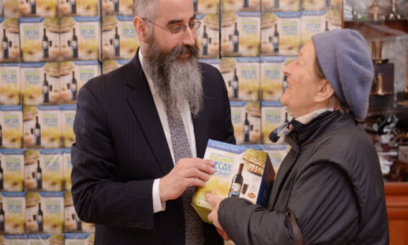הרב אברהם וולף מחלק מצות [צילום: יח"צ]