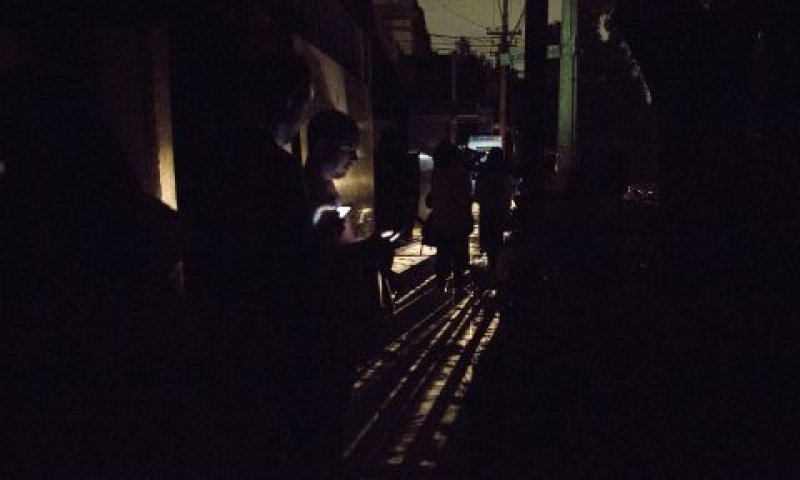 תושבים בחשיכה מחוץ לבתים [צילום: רבקה בלקוול/AP]