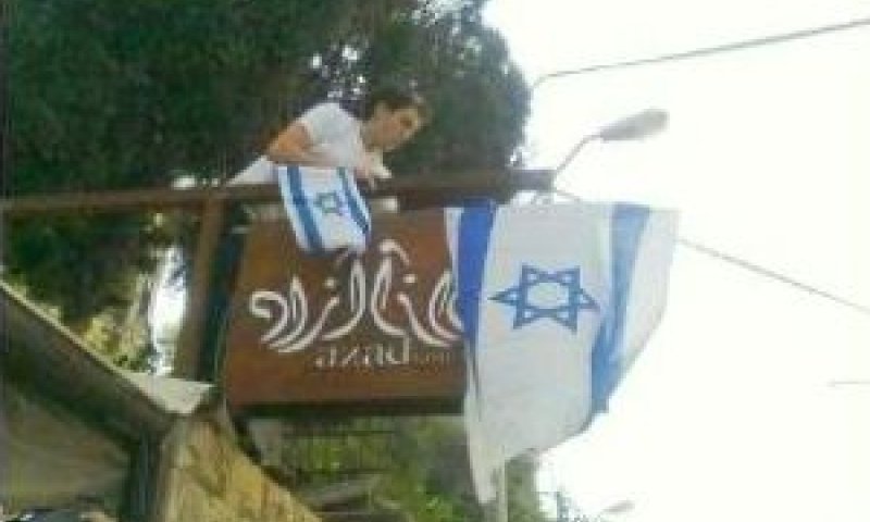 תולים דגל ישראל מעל שלט המסעדה [צילום: אודיה שווץ]