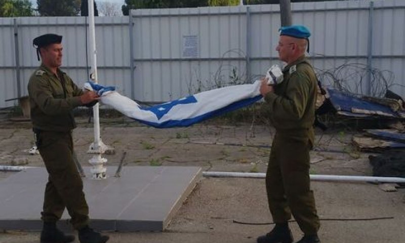 אל"ם רן קינן מפקד בה"ד 6 מקפל את דגל הבסיס [צילום: משרד הביטחון]